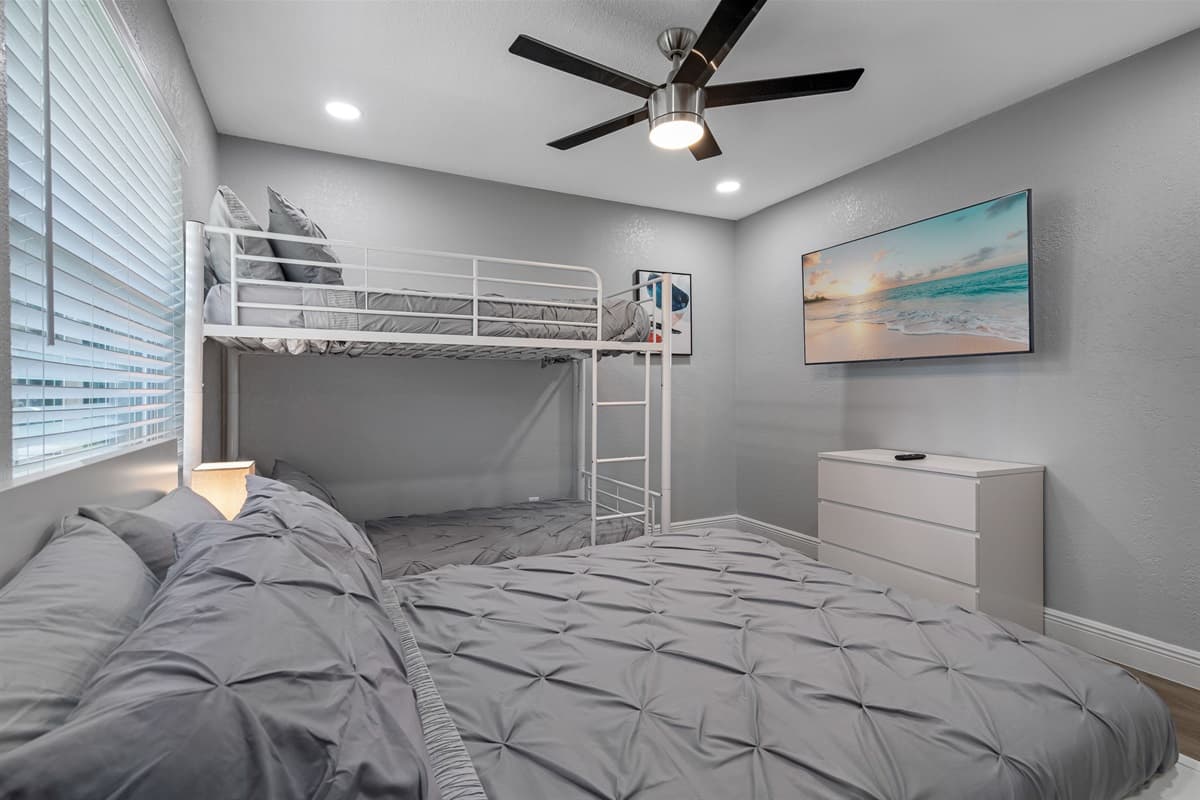 This elegant bedroom is perfect for a small family or group of friends! It has a queen sized bed, single bunkbed, drawers for storage and a smart TV! Book this property now!
