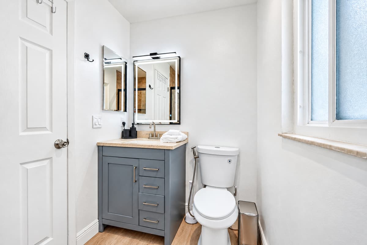 A bold backlit vanity light makes morning prep and evening wind-down routines feel special.