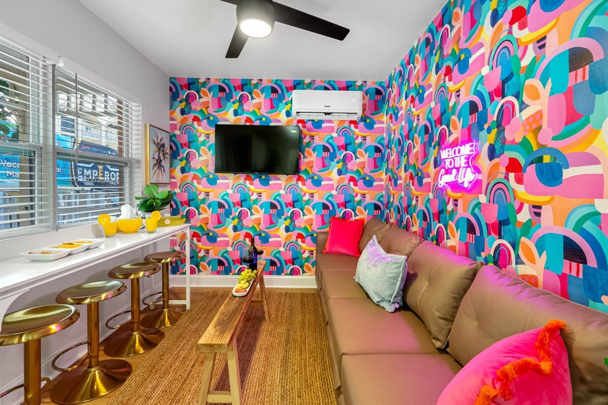 The colorful living area is a feast for the eyes, with walls adorned in refreshing hues that immediately uplift your spirits.