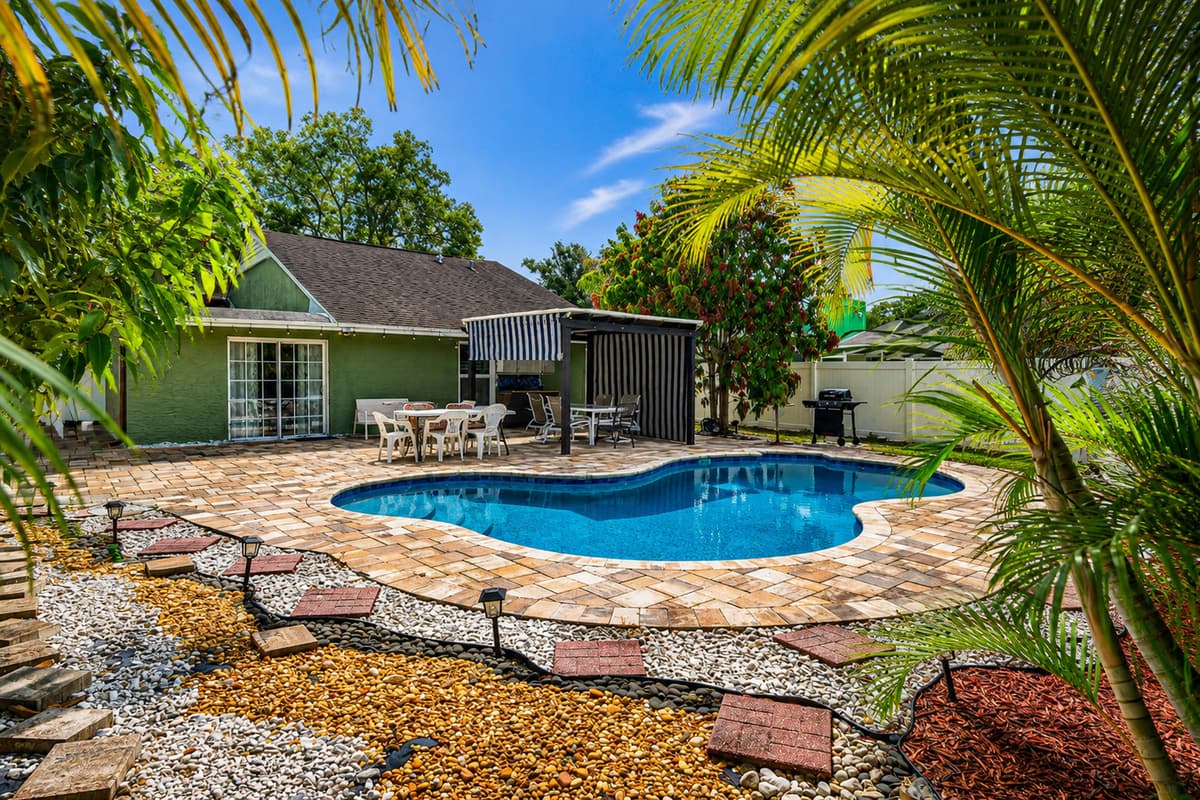 Surrounded by lush landscaping, this backyard oasis is perfect for soaking up the Florida sunshine.