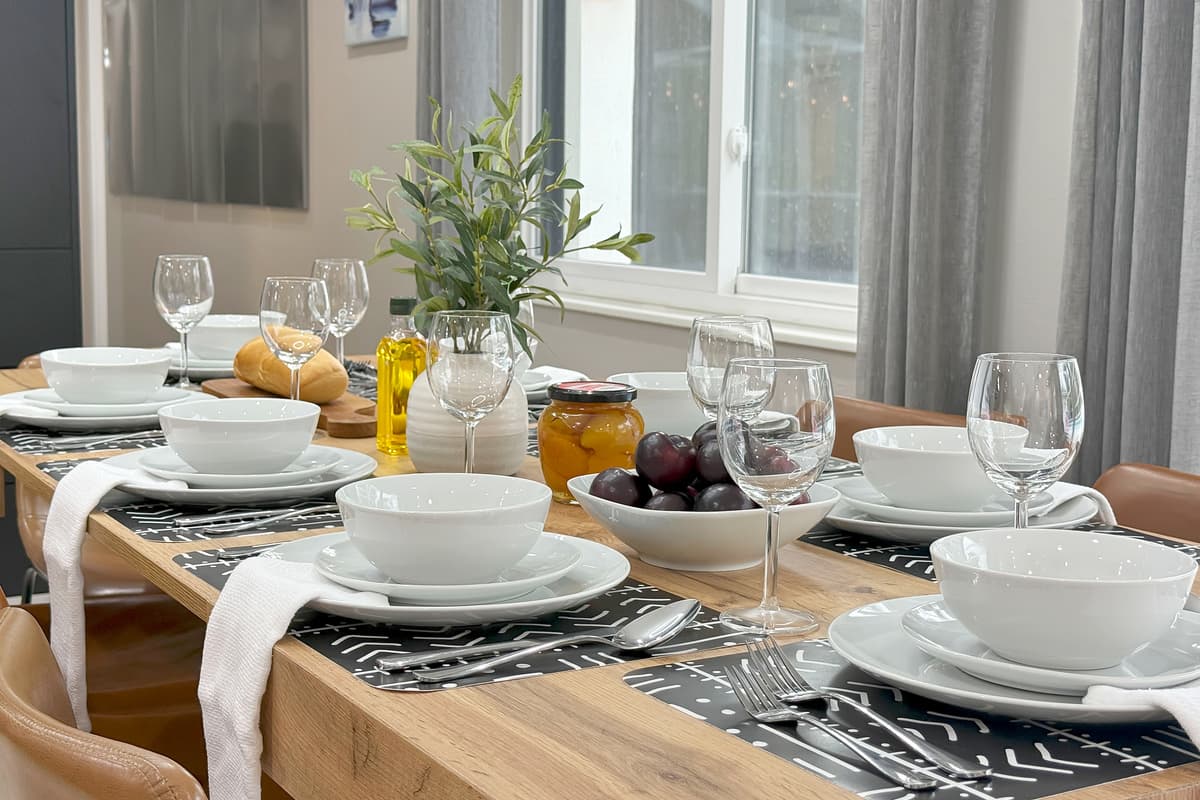 Plates stacked, silverware aligned, glasses in place — the kind of order that turns "where do I find the forks" into "let's eat."