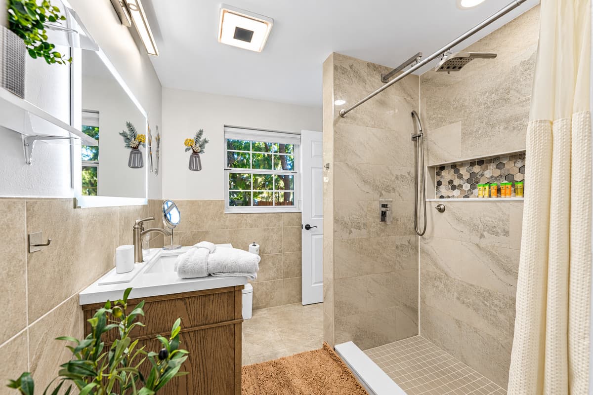 A serene bathroom retreat featuring neutral tones, elegant finishes, and a bright, airy layout.