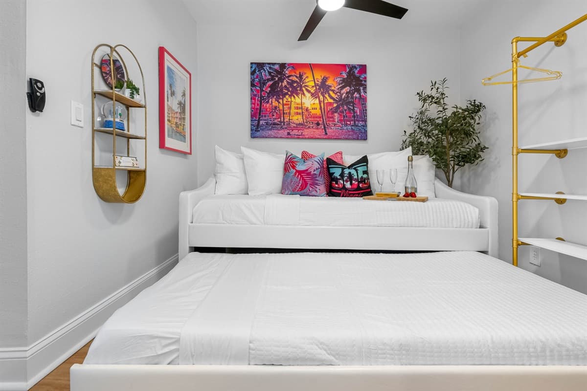 Here, a cozy twin-size bed is complemented by a convenient trundle, perfect for accommodating additional guests or providing extra sleeping arrangements.