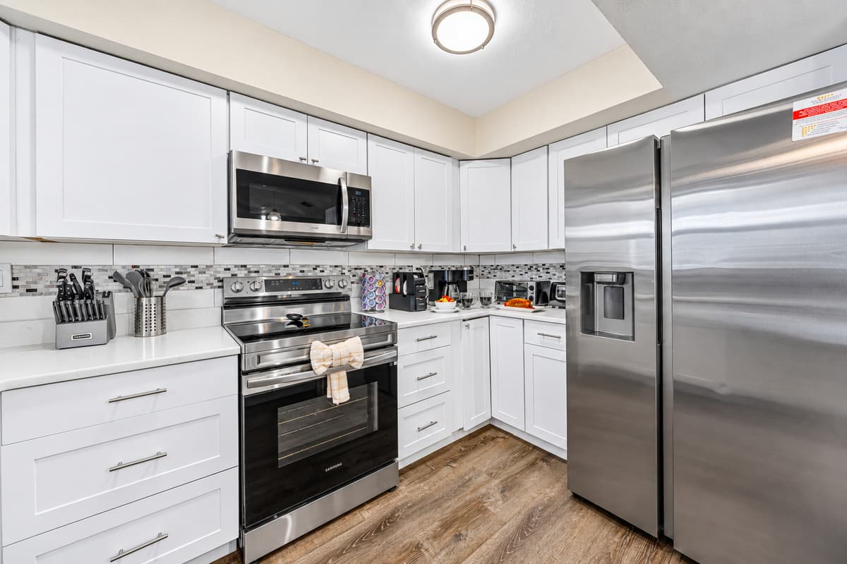 Cook with ease in the well-stocked kitchen with modern appliances and ample storage.