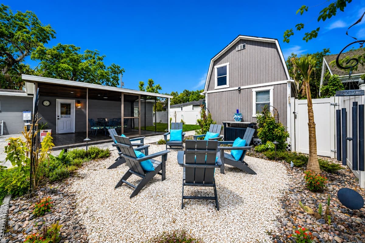 Beautifully landscaped outdoor corner with charming garden accents and backyard seating area.