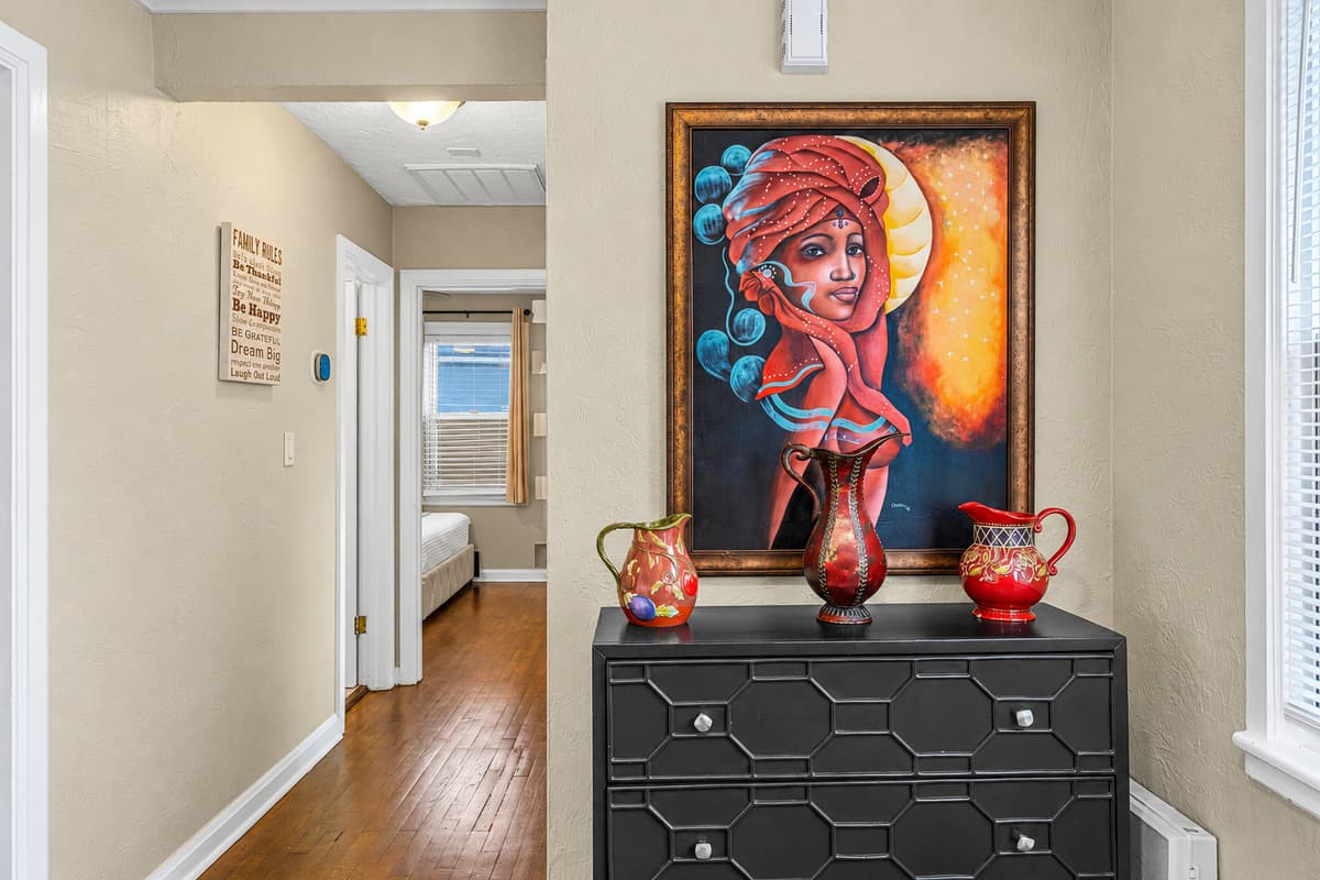 Tastefully decorated hallway with artwork and accents adding character to the home.