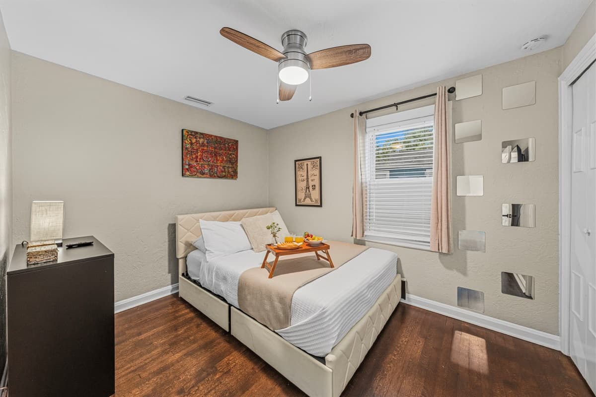 Stylish bedroom with plush bedding, modern décor, and warm natural lighting.