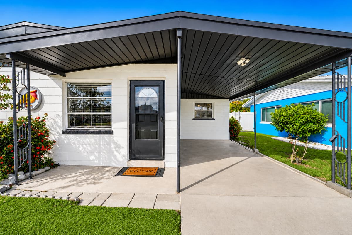 Covered front porch with private driveway access and inviting exterior design.