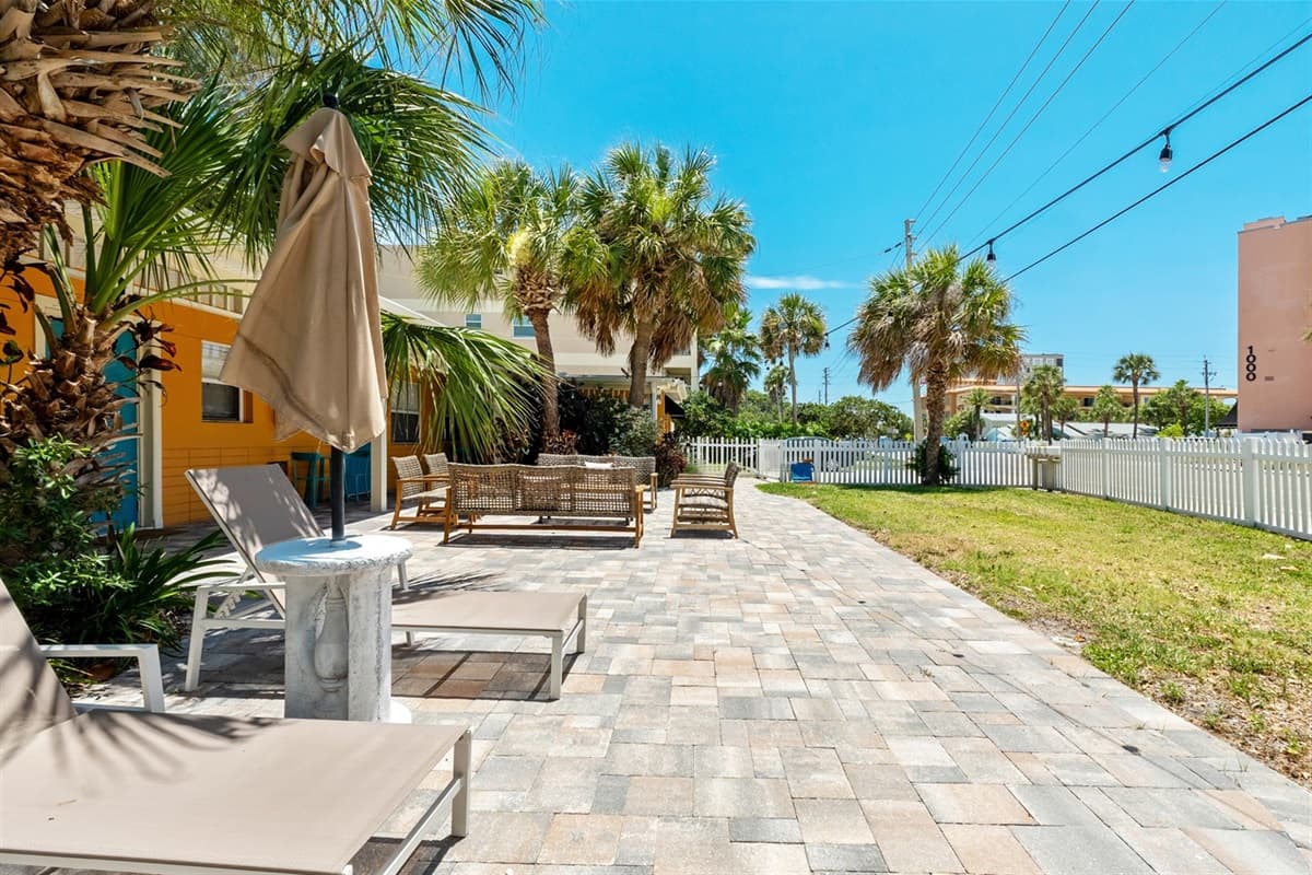 Comfortable, weather-resistant sofas and armchairs are arranged in cozy groupings, creating an ideal spot for gathering with friends and family.