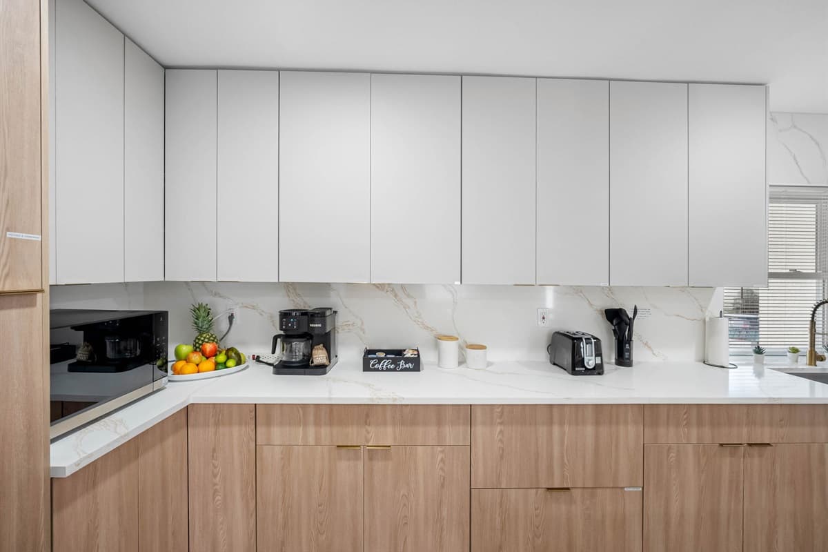 A bright, airy space where natural light flows through the large window, illuminating every corner of this thoughtfully crafted kitchen. Fully equipped and ready for your next culinary creation.