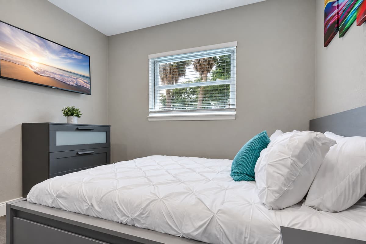 Comfortable bedroom with king sized bed, smart TV and drawers. Sleep safe and sound on the comfort of your home away from home. 