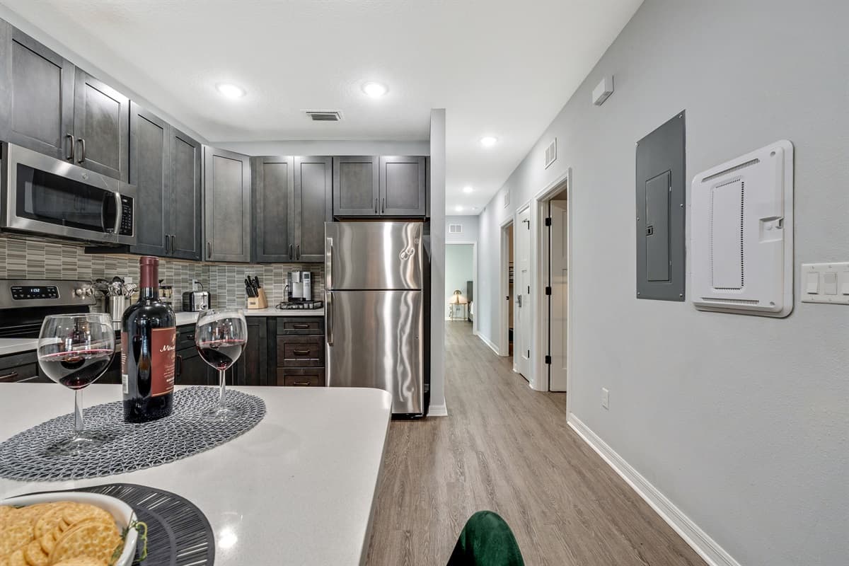 The open concept allows for seamless transitions between different cooking zones, making it a dynamic space for both solo endeavors and collaborative culinary creations.