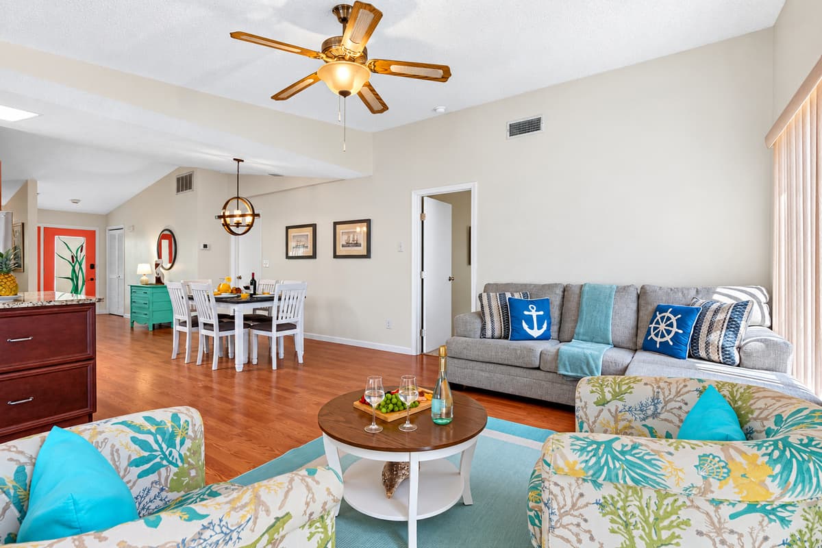 The natural light streaming through the windows enhances the room's airy ambiance, creating an inviting atmosphere ideal for relaxation and social gatherings.