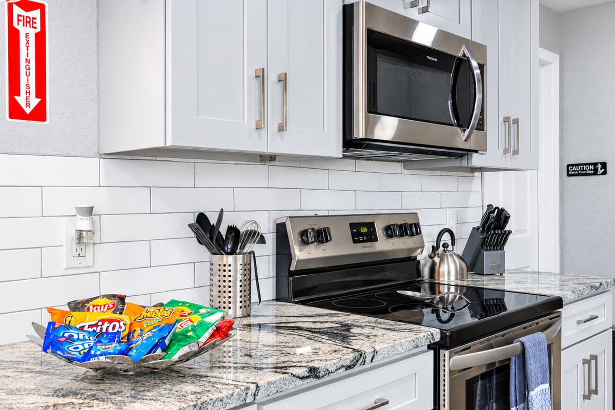 Snacks, range, and room to prep. Stainless range and microwave with plenty of counter space. Make quick snacks for the kids or full meals for the whole group.