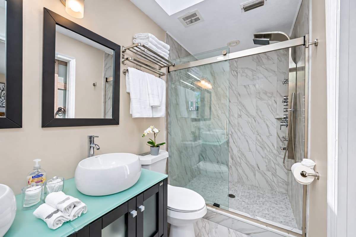 Stunning bathroom with sink, toilet, and walk-in shower.  Enjoy a relaxing bath after a long day of travel from your home to your home away from home. If you like this property, send us a message now!