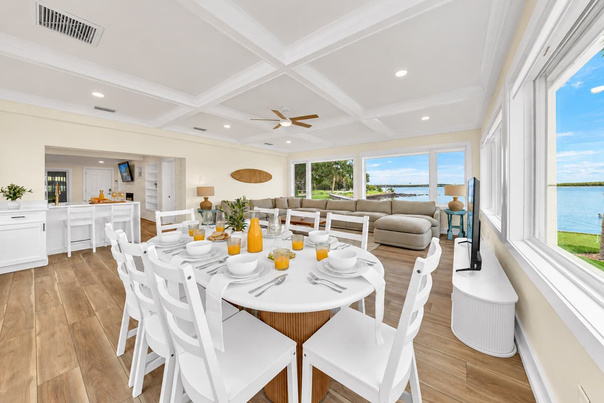 Dinner by the windows. The round dining table sits beside the waterfront windows. Watch the light change over the bay while you eat.