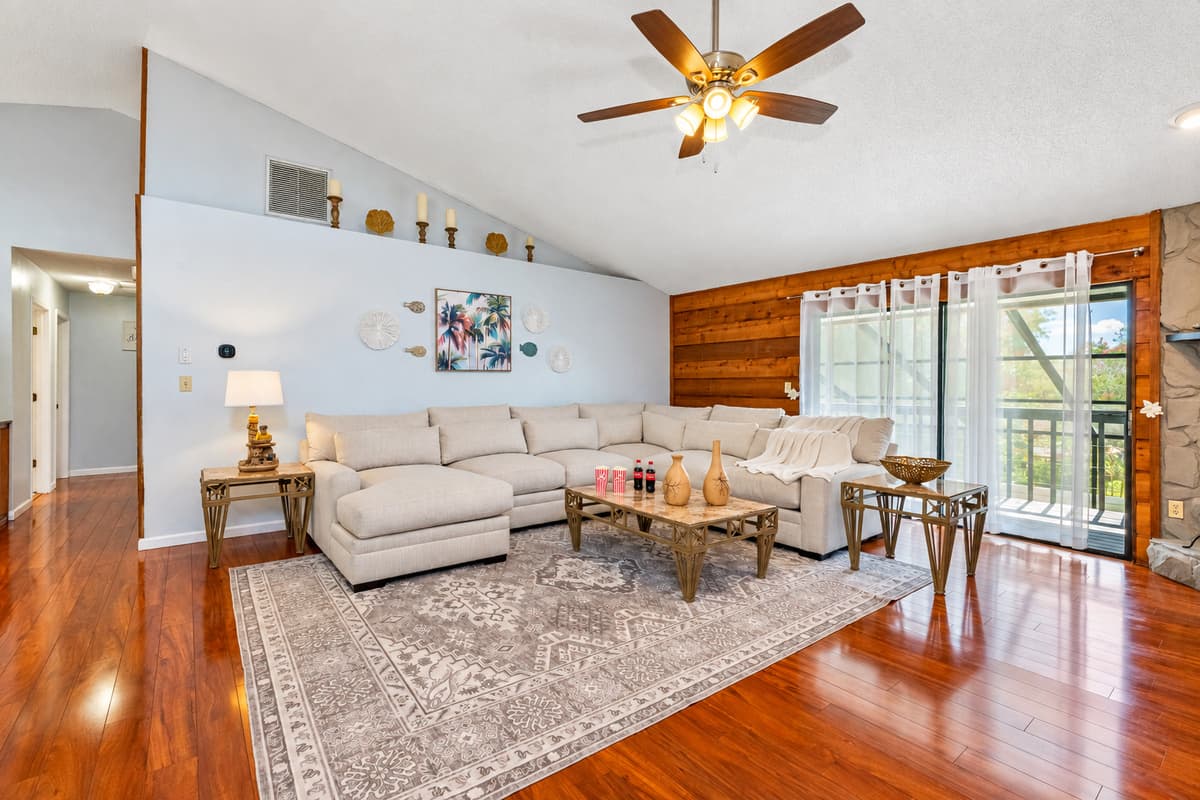 This spacious living room combines coastal decor with warm wood finishes and soft textures—making it an ideal spot to gather, recharge, and feel at home.