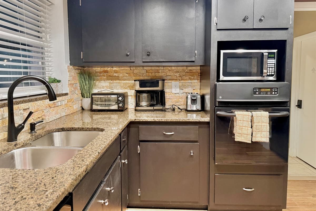 With ample granite countertop space, dual sinks, and a clean, organized layout, this kitchen is ideal whether you're preparing family dinners or late-night bites.