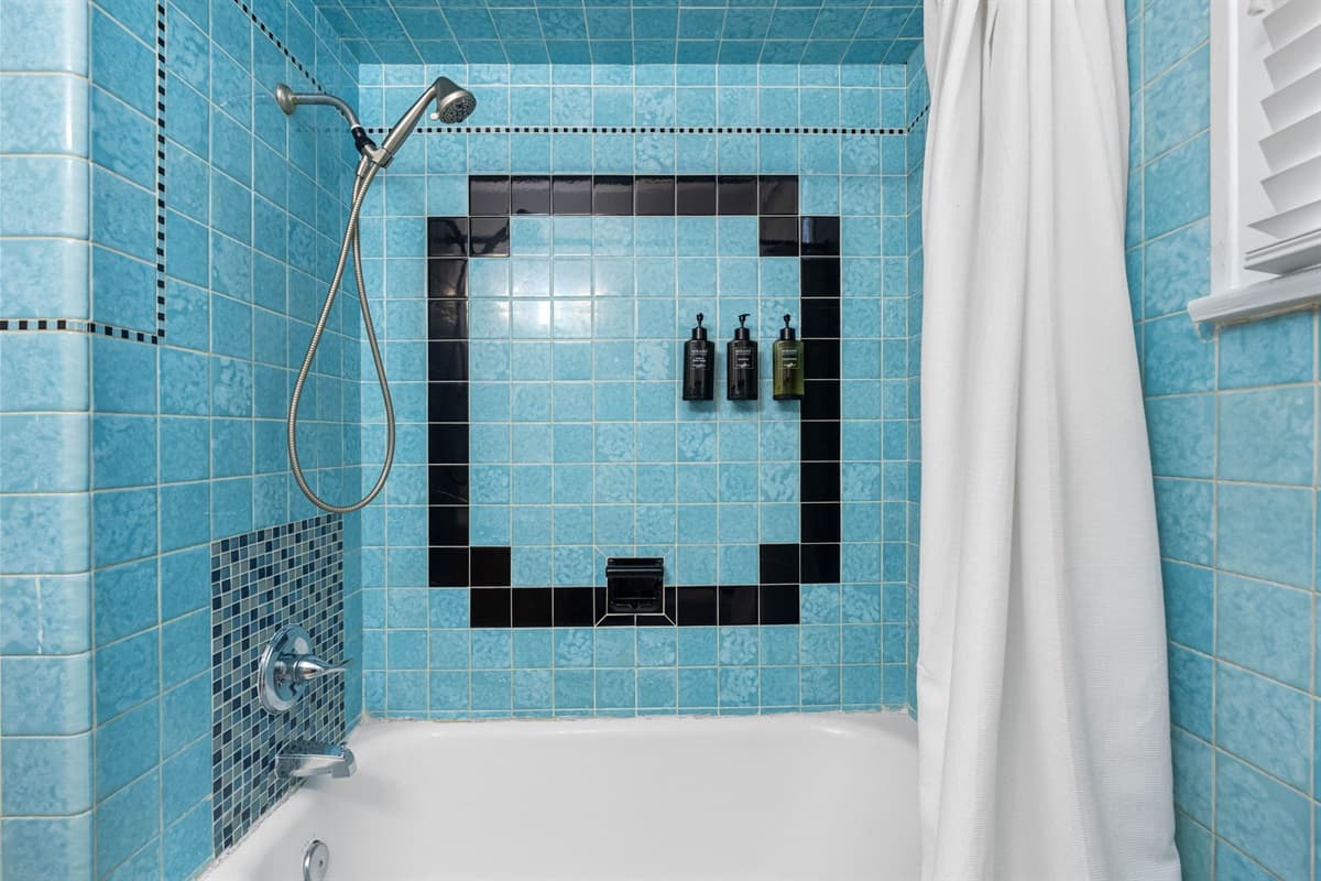 The tiled walls, with their subtle yet sophisticated patterns, enhance the overall aesthetic, providing a luxurious atmosphere.