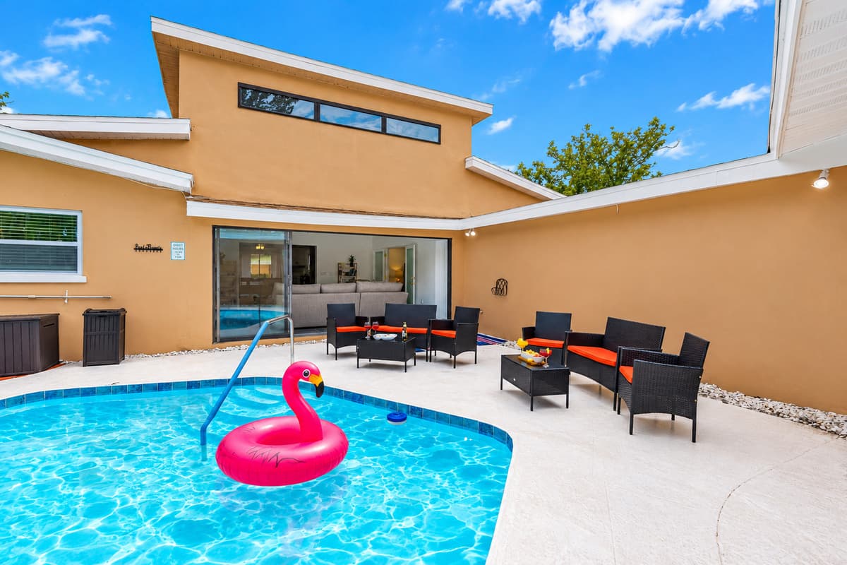 Surrounded by tropical landscaping and string lights, this poolside oasis is perfect for both sun-soaked afternoons and magical evenings.