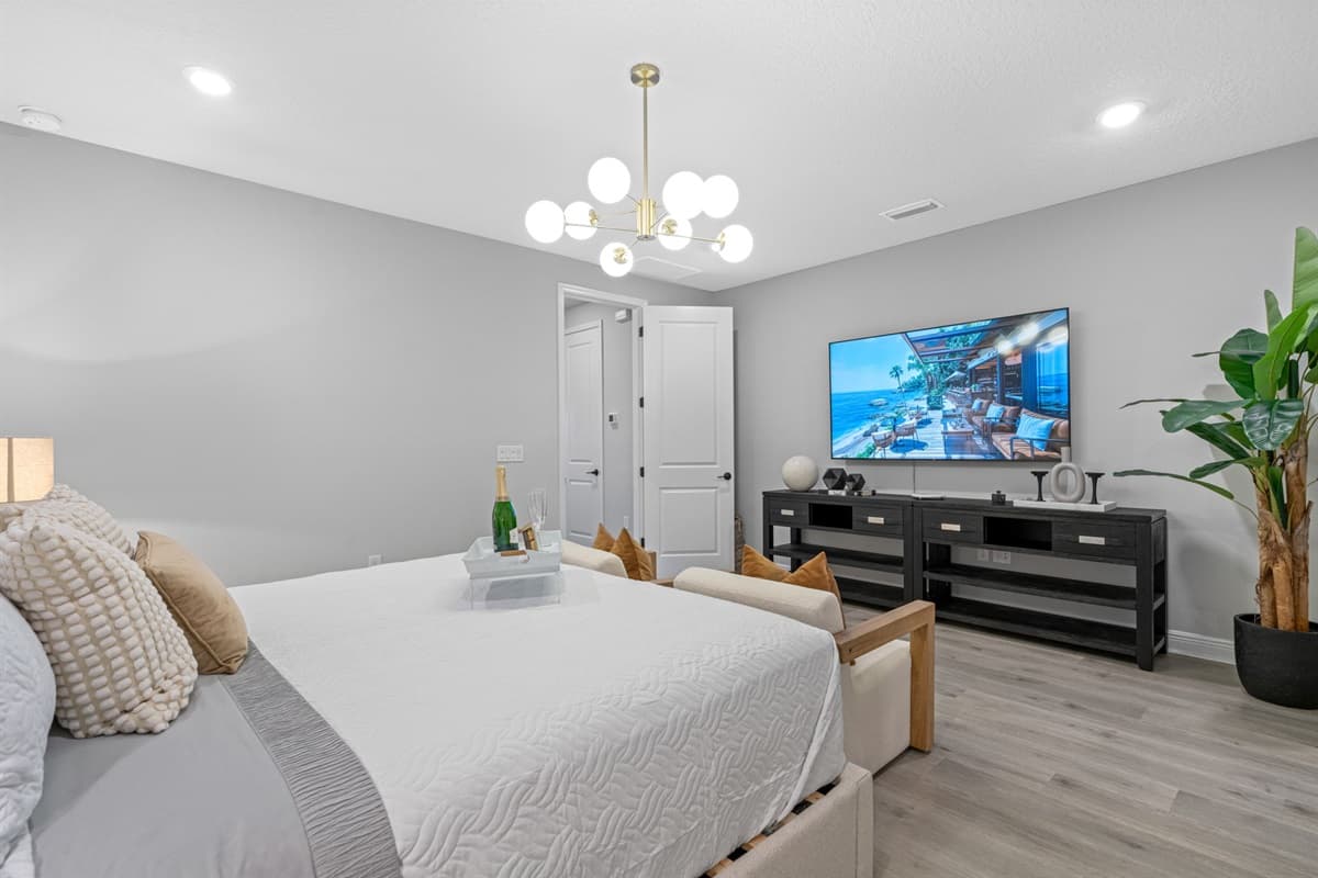 At the center of the room stands a luxurious king-sized bed, its plush mattress and sumptuous linens promising a night of unparalleled comfort.