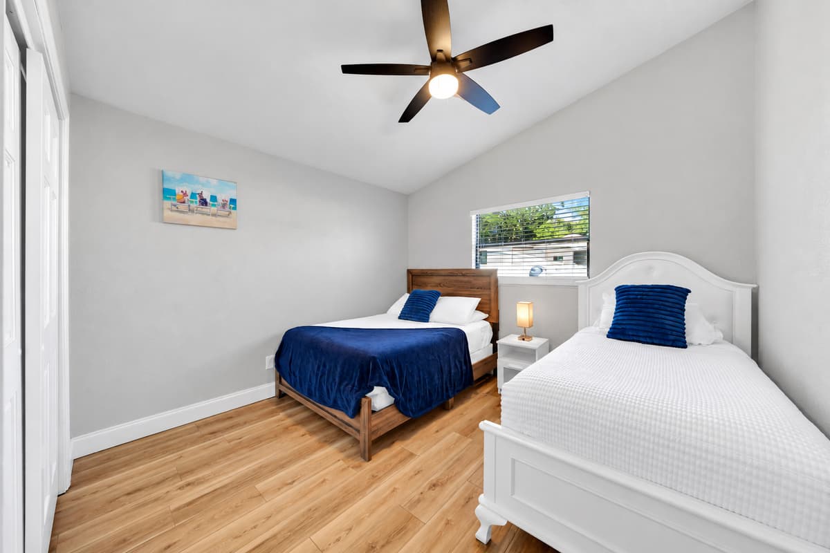 A full bed and a twin make this the most useful room in the house: two kids, two friends, or one guest with room to spread out. Big closet, a ceiling fan, and everything within a few steps of both full bathrooms.