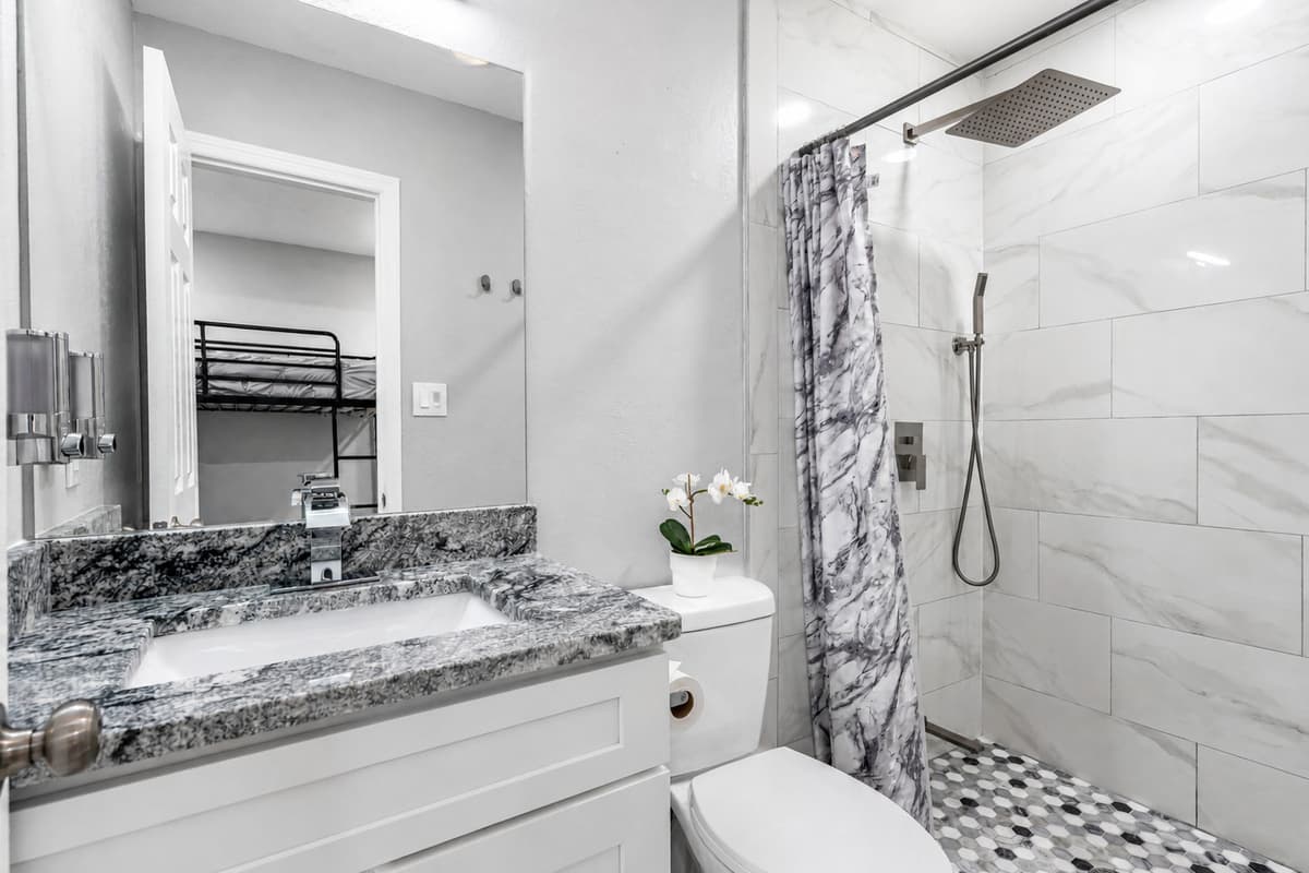 Feel refreshed in this stunning bathroom with sink, toilet, and walk-in shower.  Enjoy a relaxing shower after a long day of travel from your home to your home away from home. If you like this property, send us a message now!