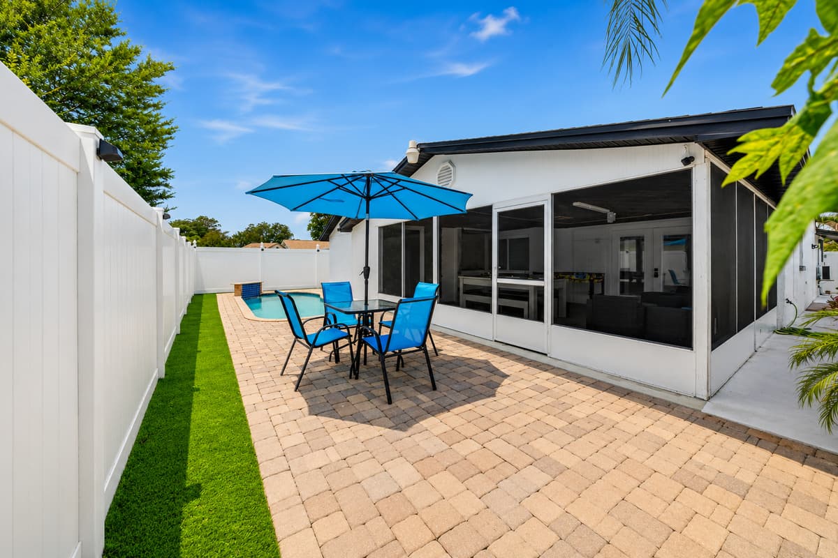 Spacious backyard retreat with outdoor dining, private pool access, and plenty of room to relax and soak up Tampa's beautiful weather.