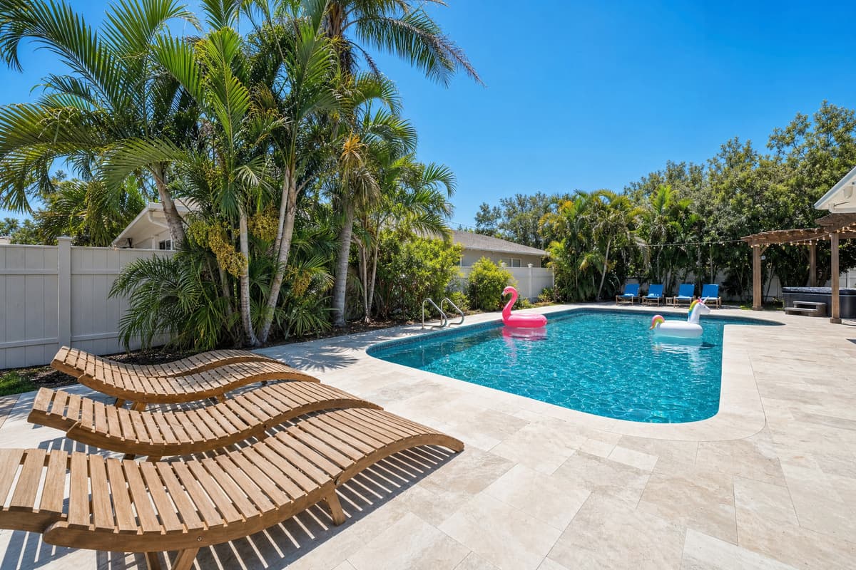 A flamingo float drifts across the pool while loungers sit ready poolside, an easy scene to picture yourself in