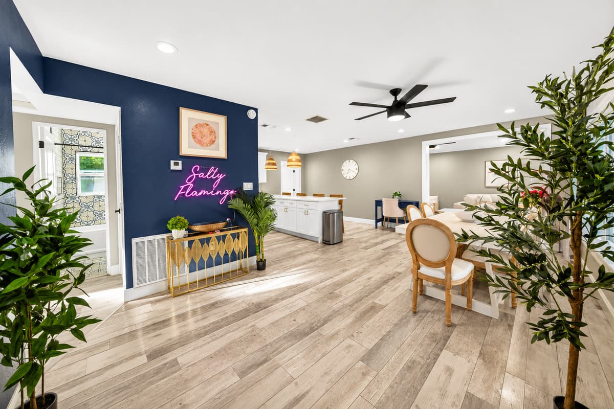 Wide view of the dining and gathering space showcasing coastal-inspired décor, open layout, and ample natural light.