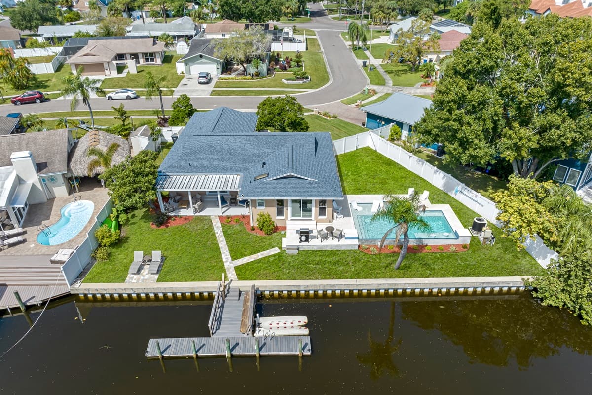 Aerial view of our beautiful property and the stunning view of the lake. Enjoy the view outside showcasing beautiful properties in the area. If you like this property, please send us an inquiry right away!