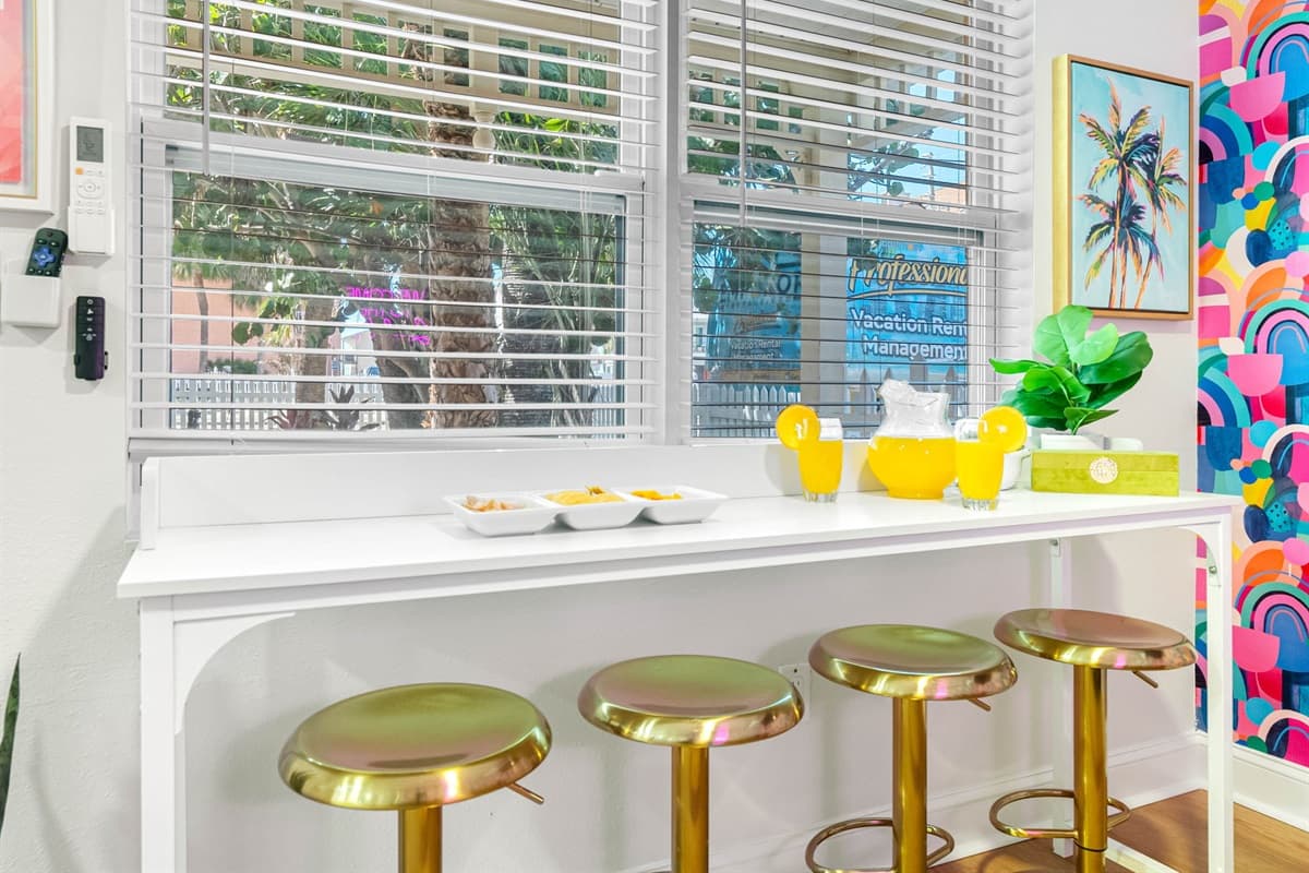 he sunlight dances off the vibrant artwork that adorns the walls, each piece contributing to the room's lively decor.