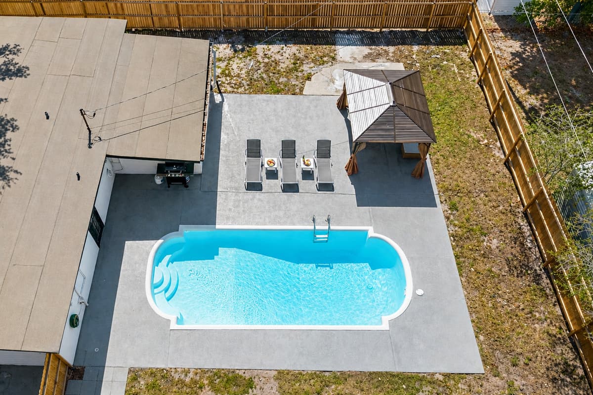 The surrounding neighborhood provides a scenic backdrop, with tree-lined streets and charming homes dotting the landscape.