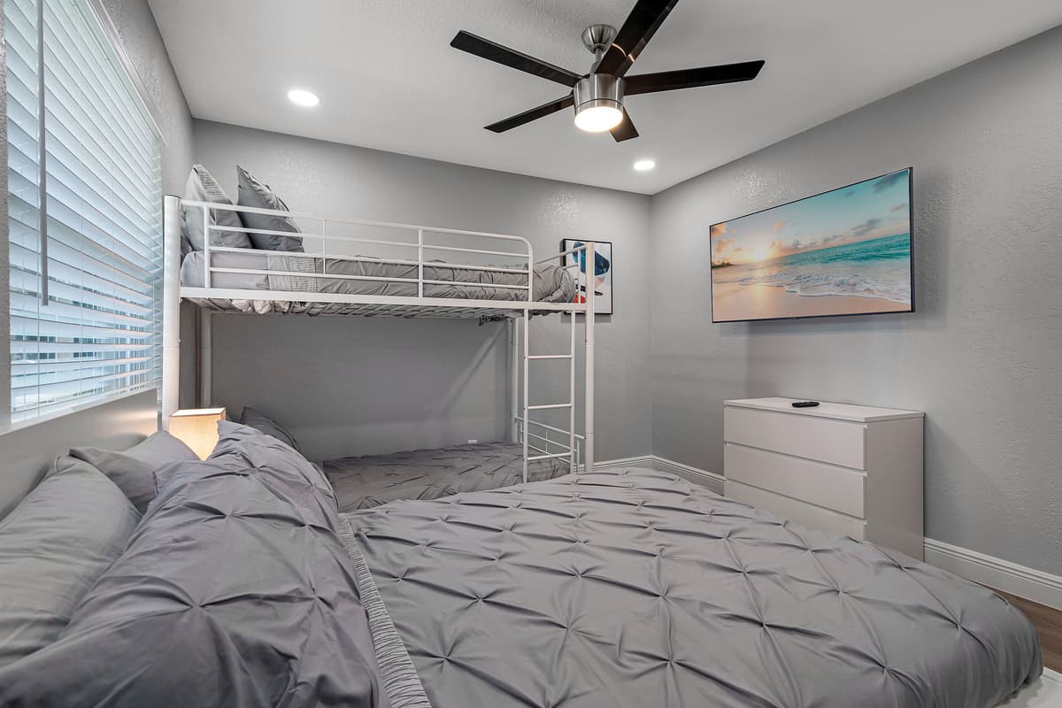 This elegant bedroom is perfect for a small family or group of friends! It has a queen sized bed, single bunkbed, drawers for storage and a smart TV! Book this property now!
