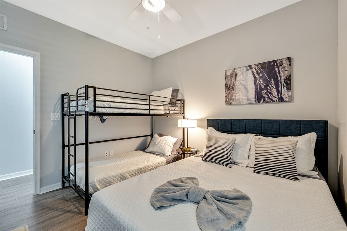 Adding an element of playful charm and practicality, the room features a captivating bunk bed, cleverly designed to accommodate a variety of needs.