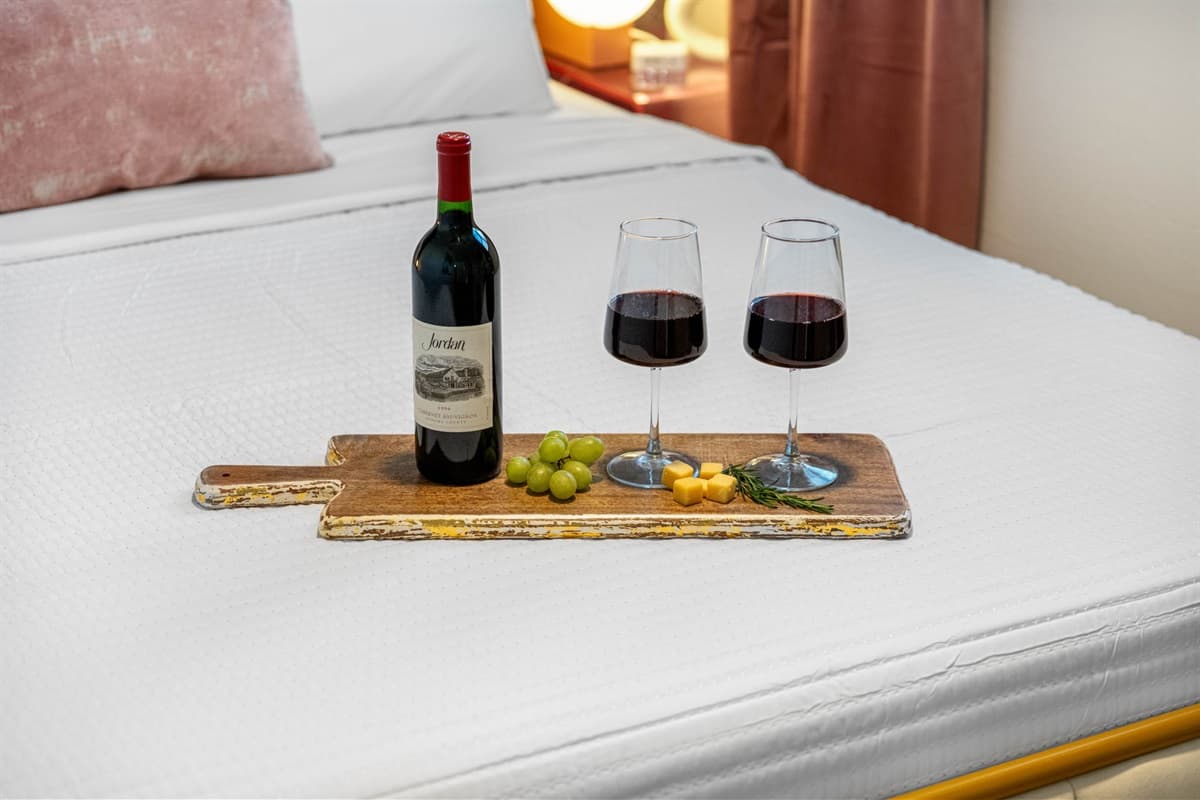 The centerpiece of Bedroom 1 is the sumptuous queen-size bed, inviting you to sink into its plush comfort.
