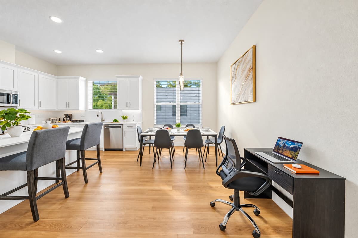 Wide view of kitchen and dining layout highlighting open-concept design.