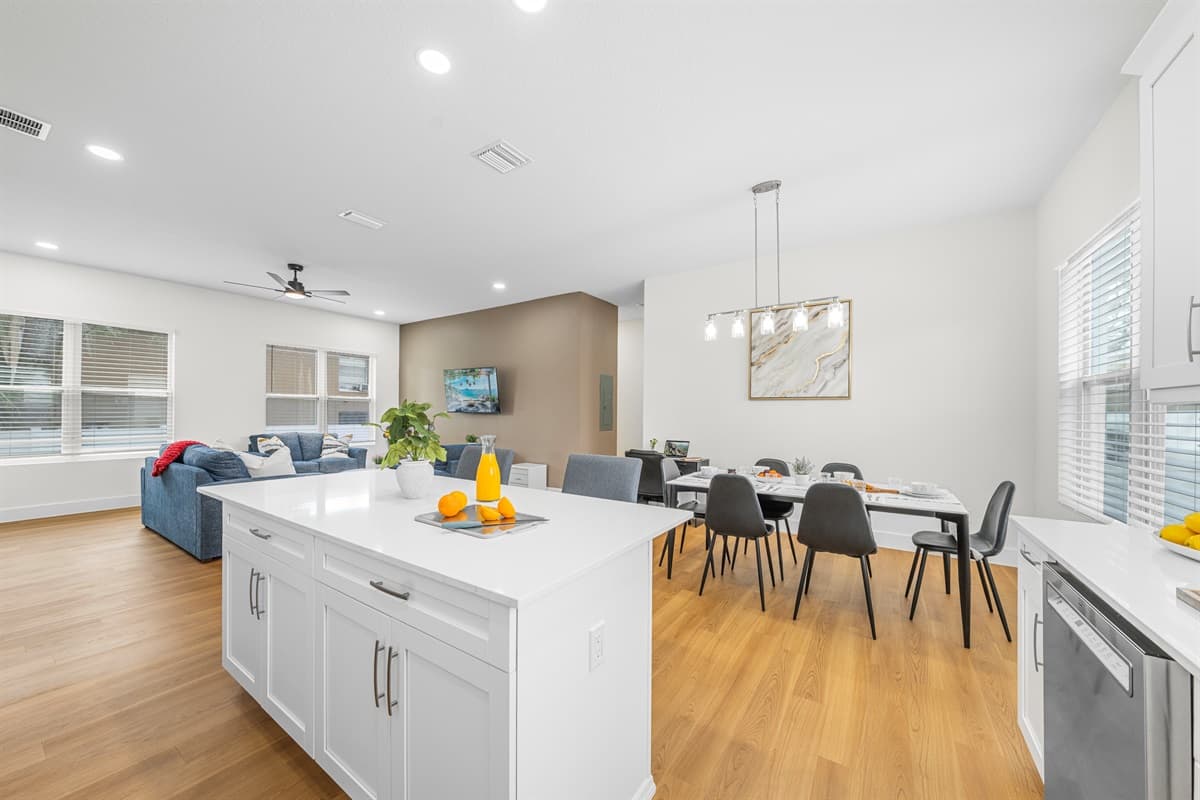 Wide view of kitchen and dining area highlighting the open, airy layout.