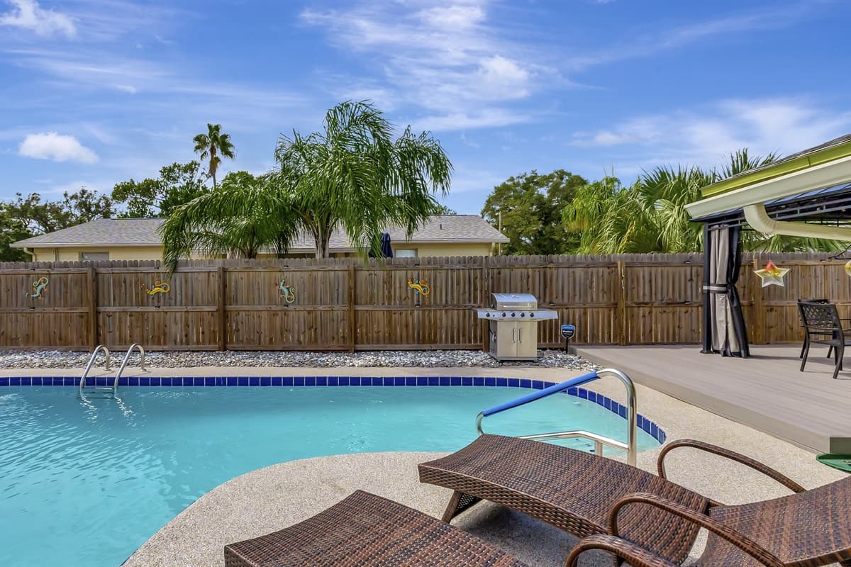 As you step onto the sun-kissed deck, the glistening waters of the pool beckon.