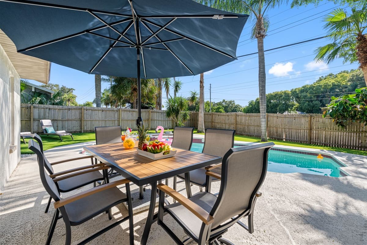 Nestled beside the shimmering waters of the pool, the dining space invites you to savor every bite while enjoying the soothing ambiance of gently rippling water and the soft glow of nearby landscape lighting.