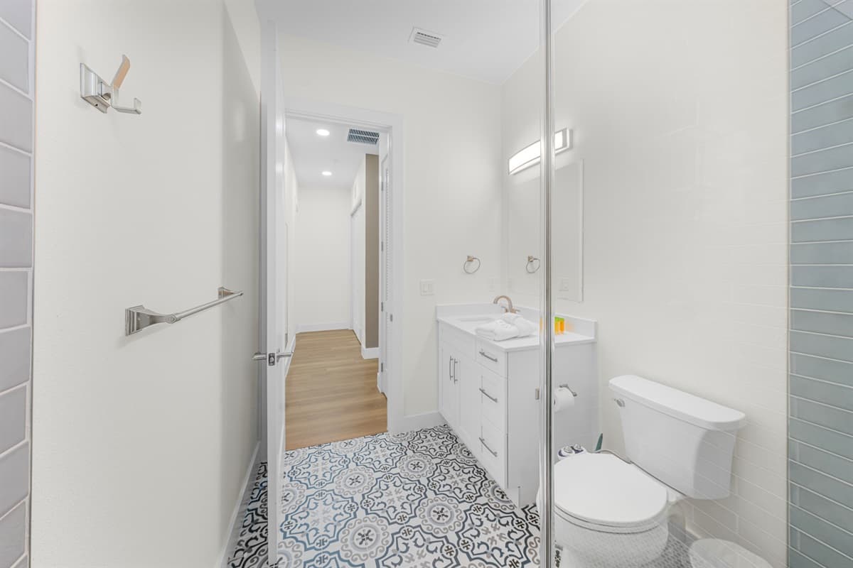 Bright full bathroom with modern vanity and clean finishes.
