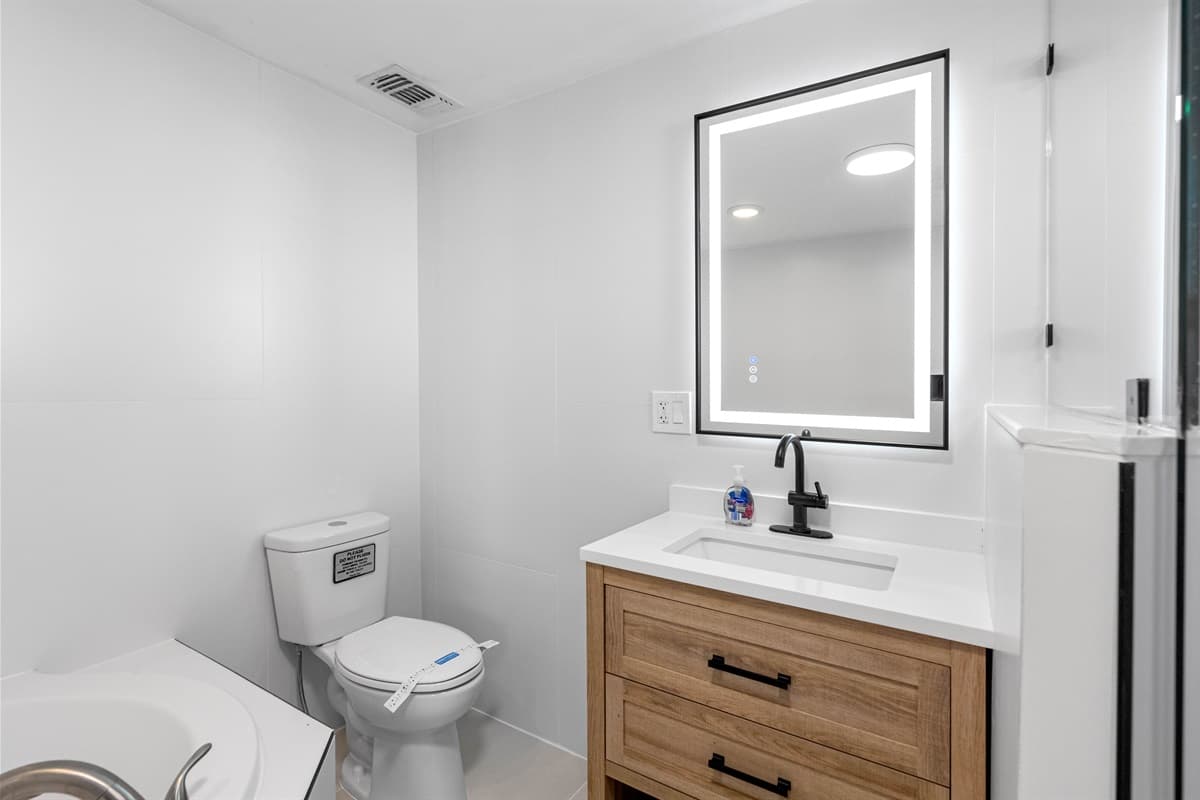 Full bathroom equipped with bathtub, sink, toilet and shower.