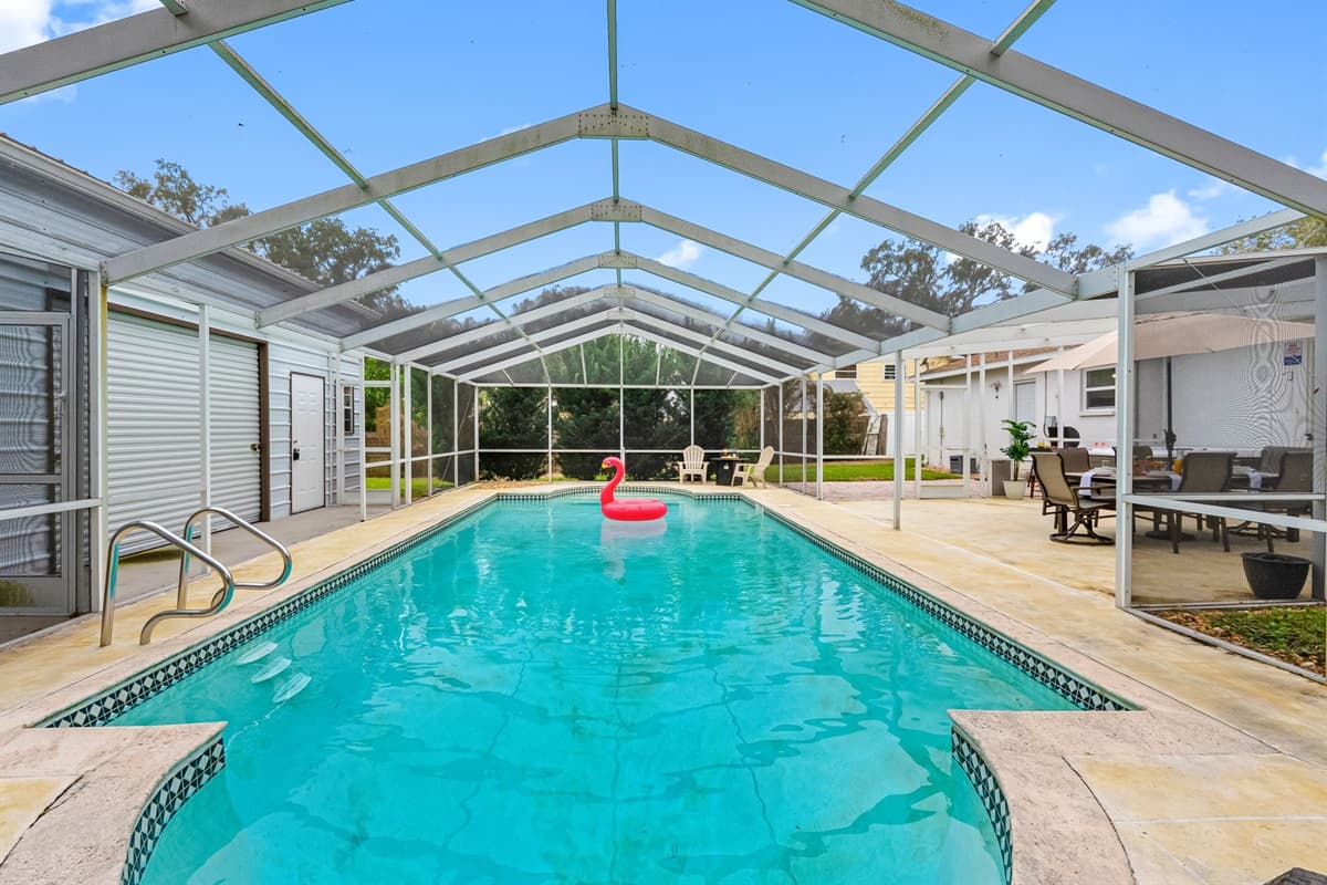 Resort-style pool area featuring comfortable loungers and plenty of space to unwind.