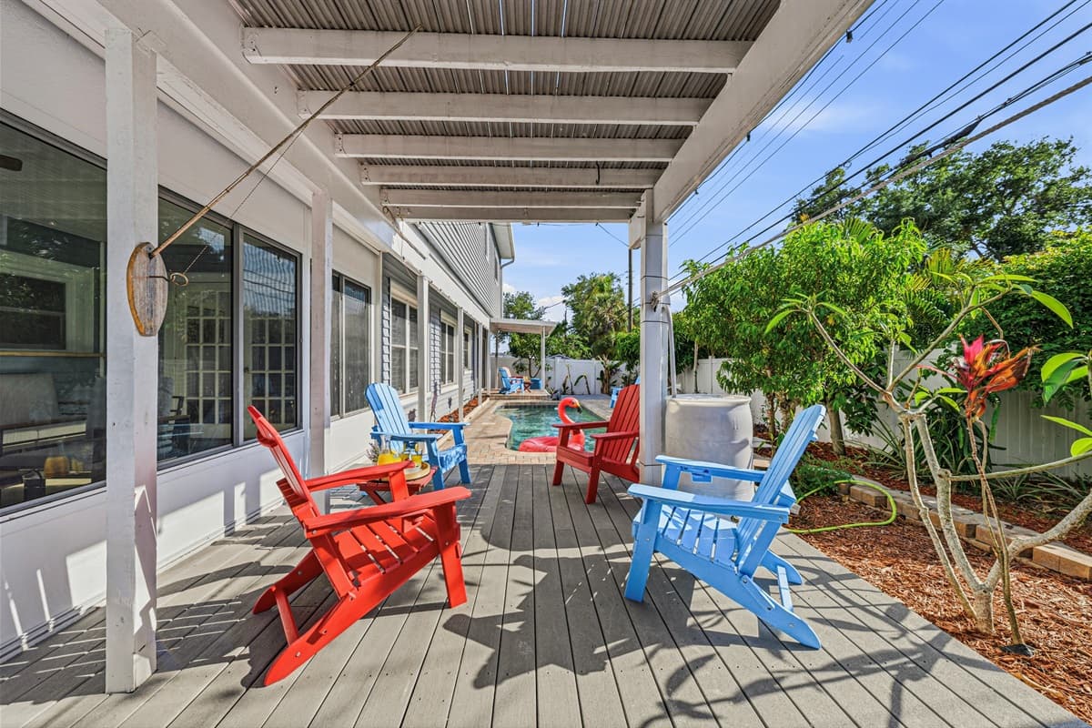 Spacious outdoor deck with colorful seating and shaded areas—perfect for gathering and unwinding 