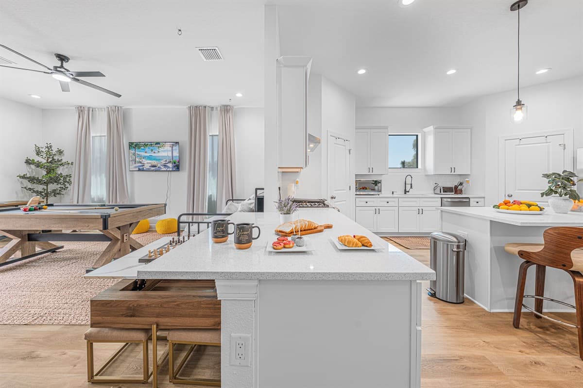 Wide view of the open-concept kitchen and living area, showcasing spacious layout and modern design.