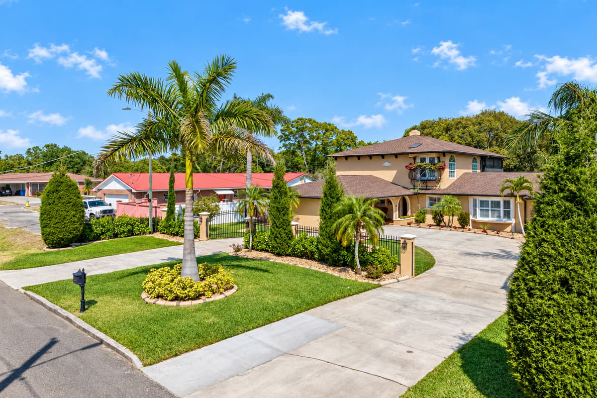 Step onto the impressive front porch and take in the magnificent view of the neighborhood, complete with towering trees and picturesque sidewalks.