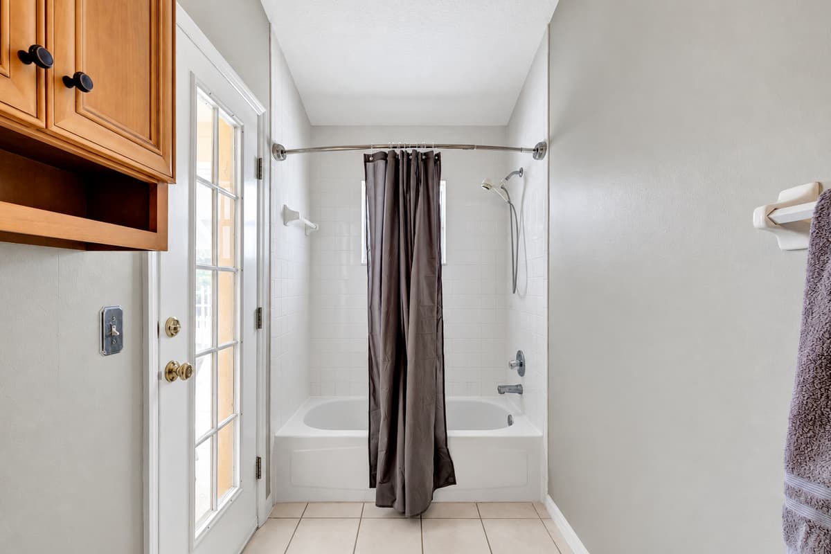 Whether you choose a leisurely soak in the tub, a revitalizing shower, or a moment of self-care at the vanity, this space promises to elevate your bathing experience to new heights.