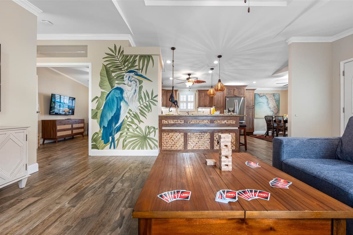A bright, open living area with plantation shutters and warm wood floors offers the ideal environment for both lounging and entertaining.