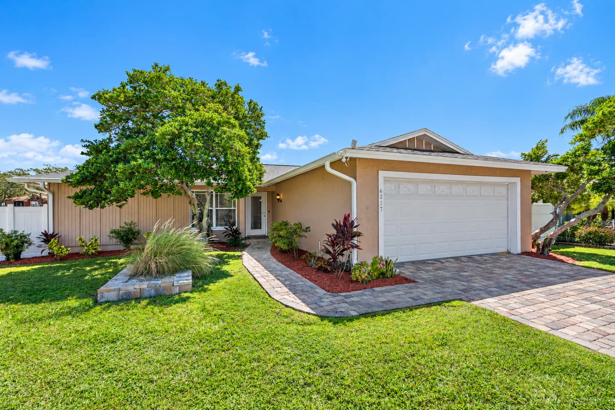 Stunning front view of the house showcasing the front yard and parking area that is equipped with CCTV cameras to ensure your safety during your stay. If you are interested in this property, send us an inquiry now!