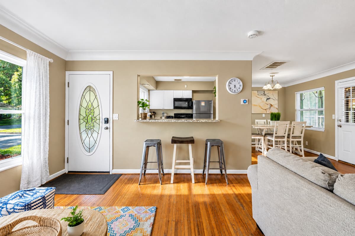 Welcoming entryway with breakfast bar seating and an open-concept layout connecting the kitchen and living room.